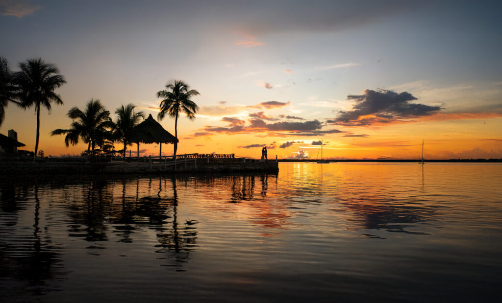 Beautiful sunset over Florida Bay with palm trees and a pier at Lover's Point