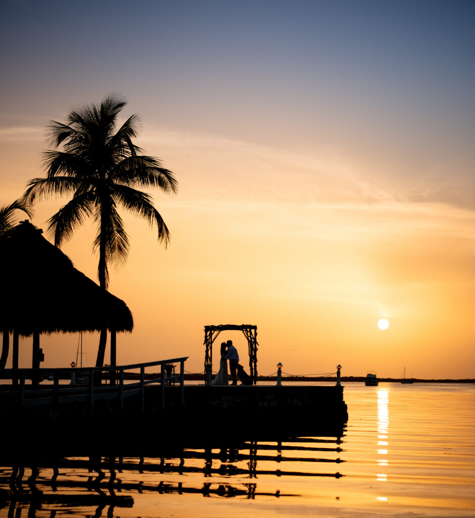 Sunset at Lover's Point with couple on a pier in Key Largo, Florida Keys