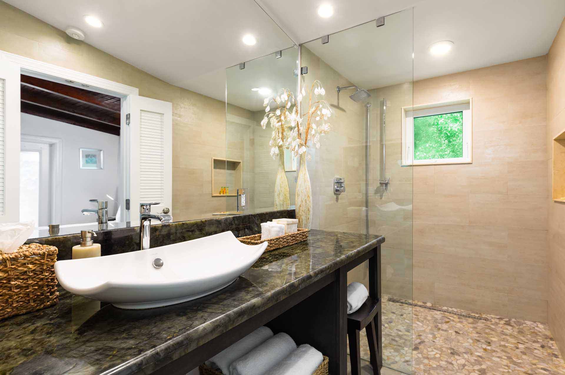 Bungalow bathroom with large vanity and rain shower - Largo Resort