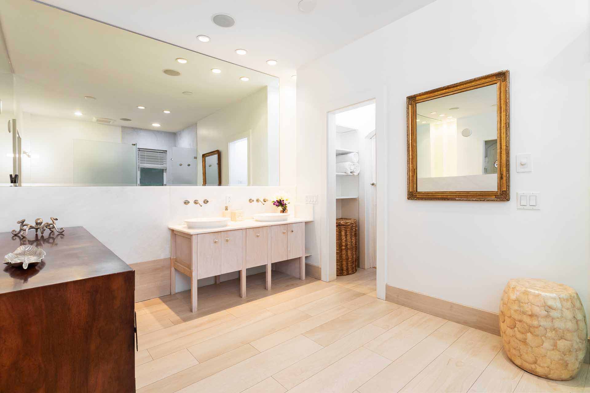 Grand Lodge bathroom with double vanity, linen closet and large mirrors