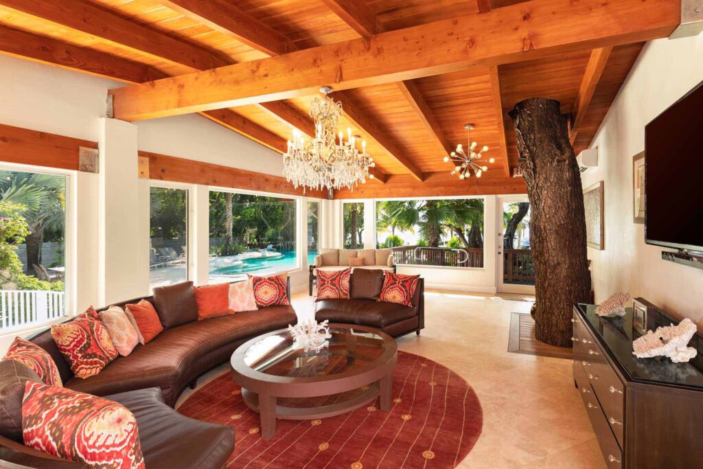 Grand Lodge large living room with comfortable sitting areas, tv, and door leading to backyard