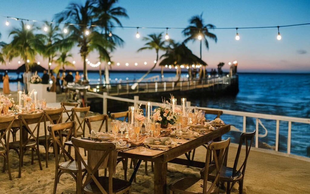 Waterfront sunset gathering at Largo Resort in Key Largo, with a long table set for a group beside the water