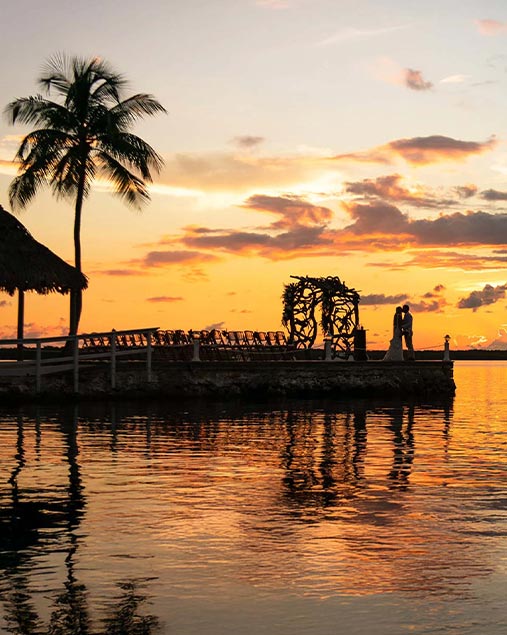 destination wedding couple on dock at Largo Resort in Key Largo Florida during sunset