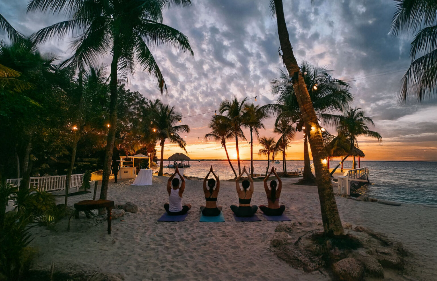 Gentle vinyasa yoga held by the water at golden hour at Largo Resort in Key Largo.