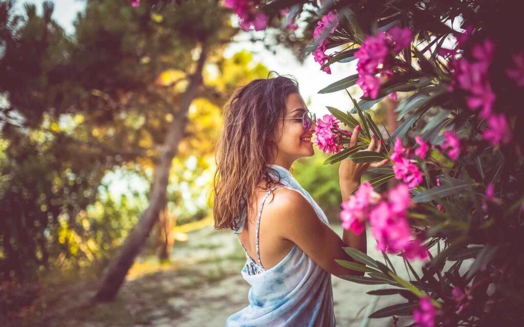 Woman smelling tropical flowers