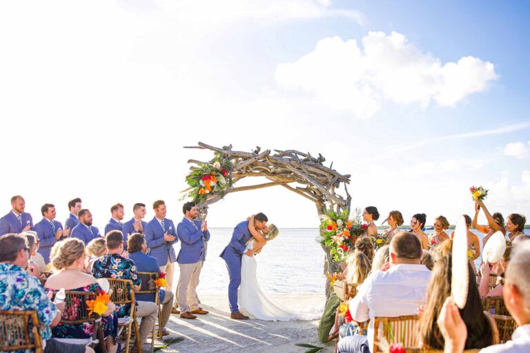 Wedding ceremony under the driftwood arch overlooking the water at Largo Resort