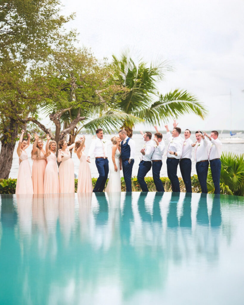 happy destination wedding party at Largo Resort overlooking florida bay and infinity pool
